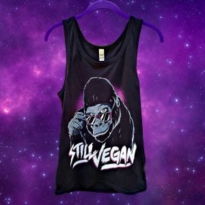 still vegan tank top gorilla wearing glasses design on a purple hanger against purple galaxy background