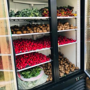 large fridge with chard kale potatoes radishes herbs