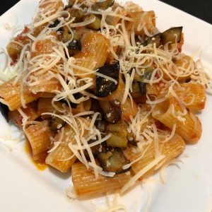 pasta on white plate with vegan cheese
