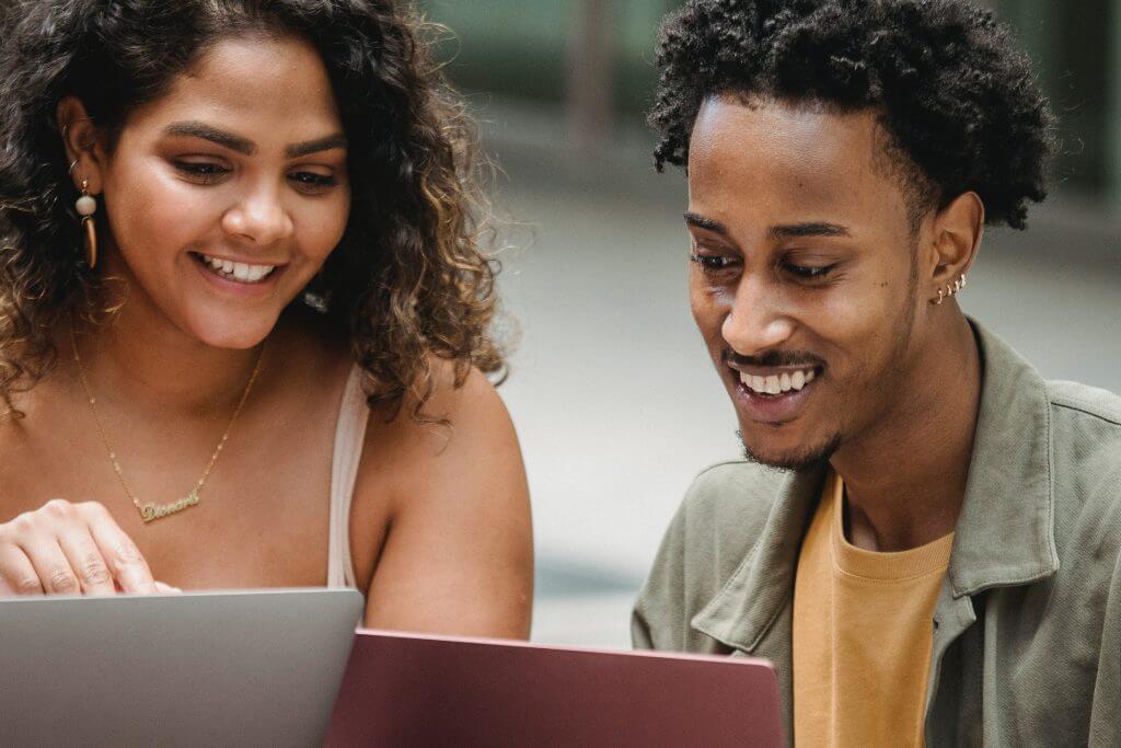 two people looking at vegan businesses on their laptops