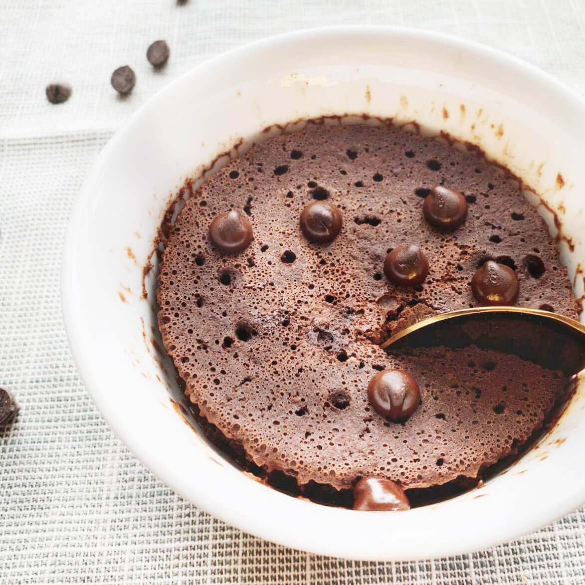 chocolate mocha cake in mug topped with chocolate chips