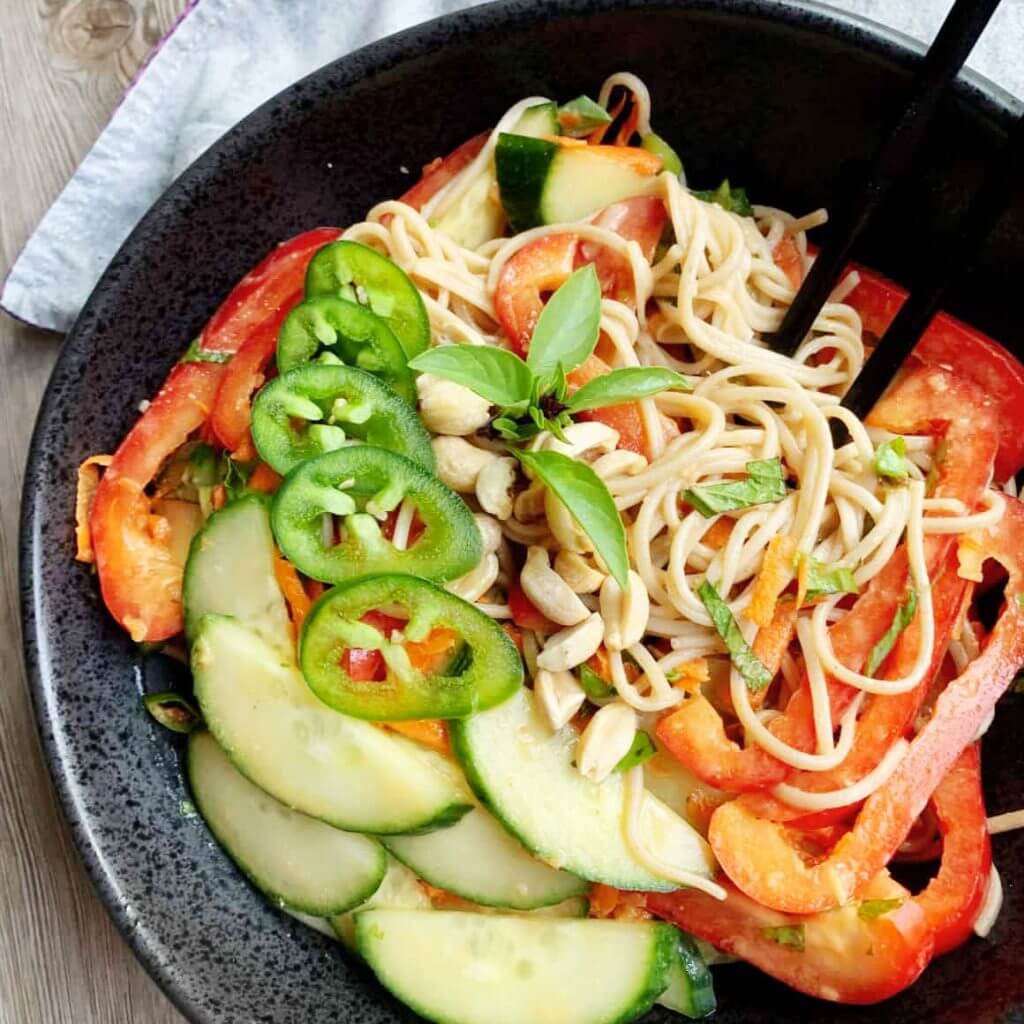 cold soba noodle salad mixed with jalepeno red pepper basil garnish