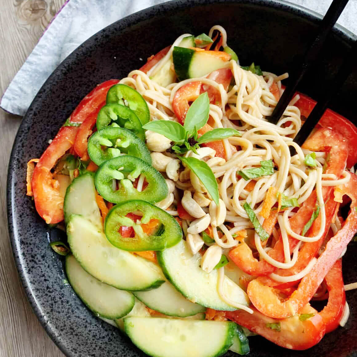 cold soba noodle salad mixed with jalepeno red pepper basil garnish