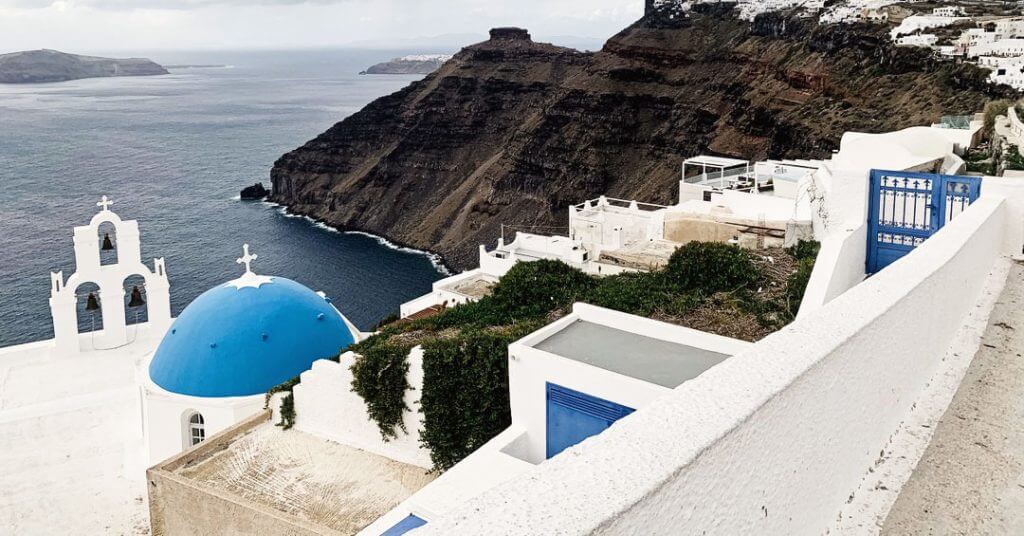 rooftop view from mod santorini overlooking the mediterranean sea church bells cliffs