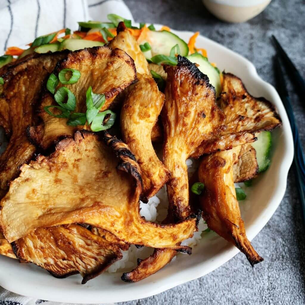 golden charred oyster mushroom bulgogi bowl with green onion cucumber carrot