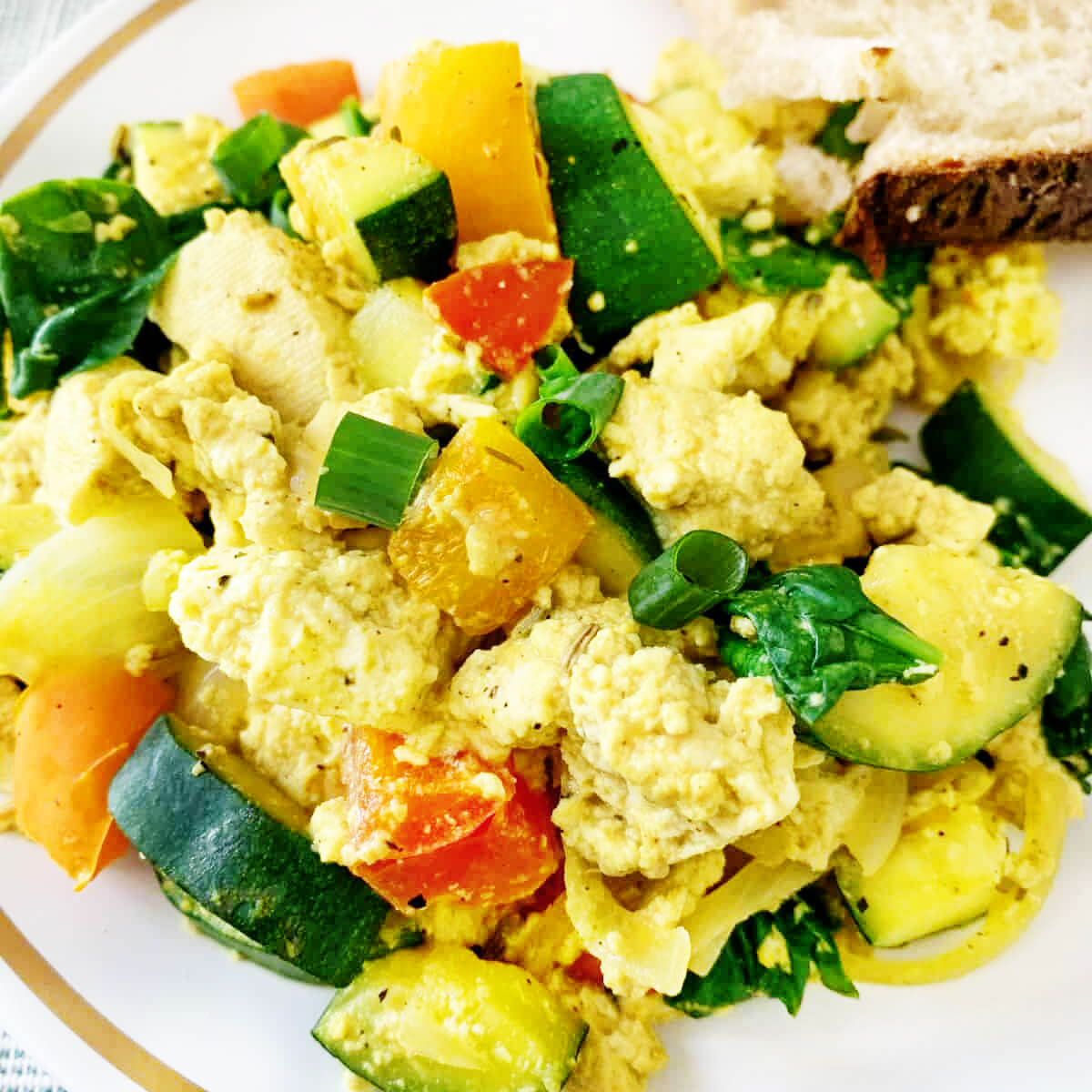 tofu scramble with tomato zucchini spinach and green onion