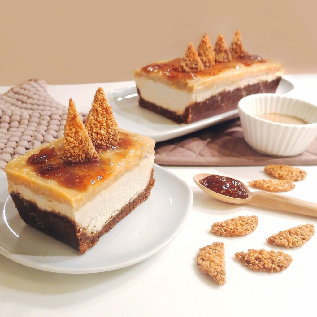 tahini caramel cheesecake topped with jam and sesame crunchy triangles
