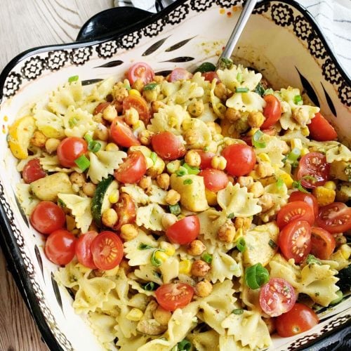 ribbon pasta mixed with tomatoes green onion chickpeas and zuchinni