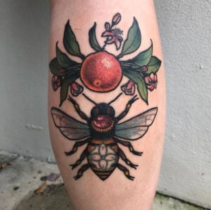 colorful bee and floral plant tattoo