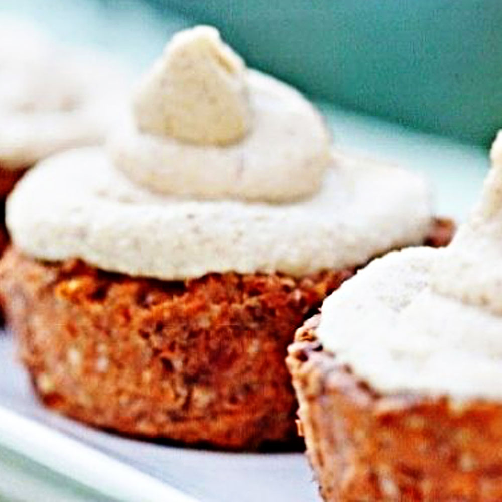 raw carrot cake cupcakes with hemp glaze and fluffy white frosting