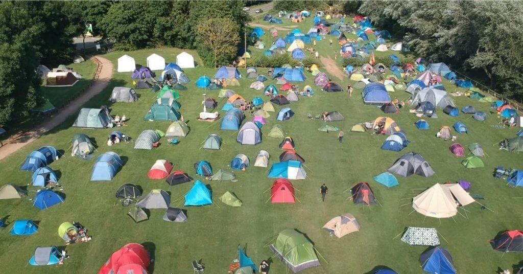 birds eye view of dozens of tents in field