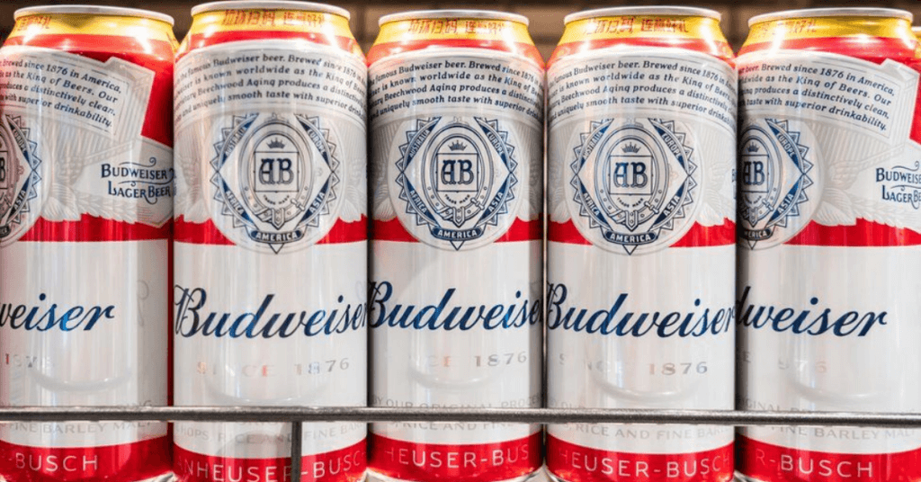 five cans of Budweiser on shelf