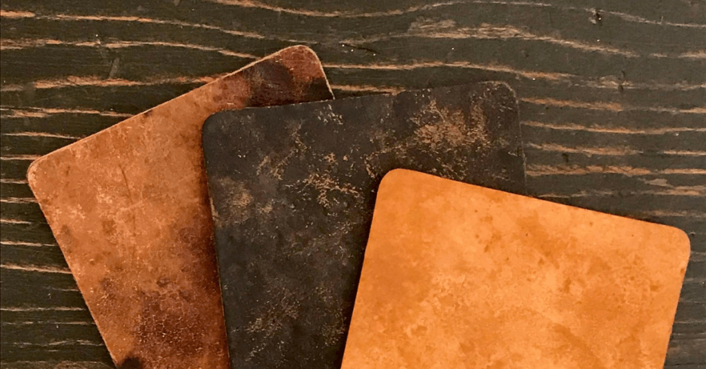 three pieces of vegan mushroom leather on wood table