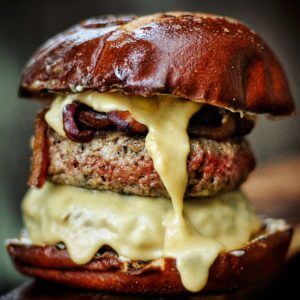 burger on pretzel bun with melted cheese