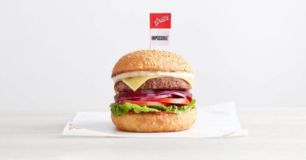 Grill'd Impossible Burger with lettuce, tomato, red onion, cheese on wrapper