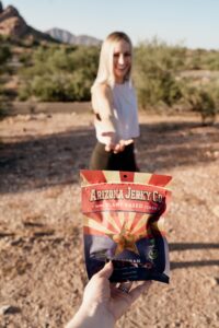 Lady Reaching for Arizona Jerky Co. Package