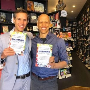 mastering diabetes authors cyrus khambatta and robby barbaro holding their book in a bookstore