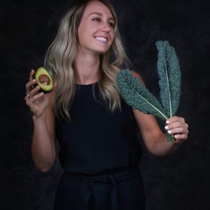 Haley Bishoff holding avocado and kale
