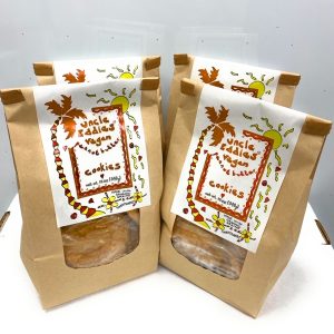 packages of uncle eddies vegan cookies brown paper bags