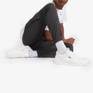 man sitting down wearing long white socks and white sneakers