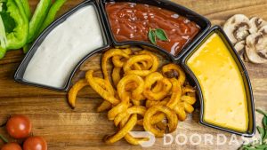 Curly fries with three dips and vegetables