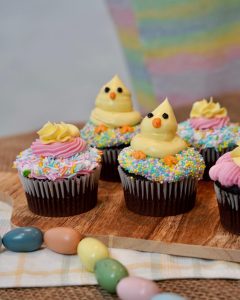Easter Glamaris Cupcakes decorated with sprinkles and yellow and pink frosting