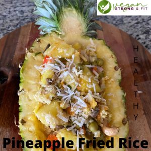 Half of pineapple filled with vegan pineapple fried rice