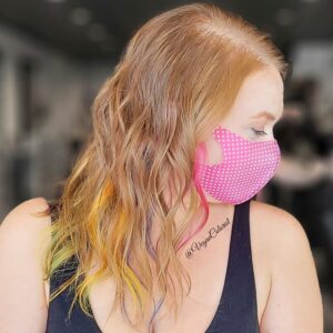 vegan colorist side profile of redhead woman with rainbow tips pink polkadot mask