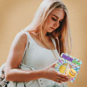teen holding vegnables cracker pack