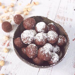 coconut bowl of wholesome bellies energy bite balls powdered sugar