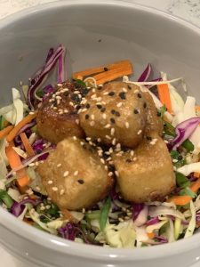 tofu salad bowl garnished with sesame seeds