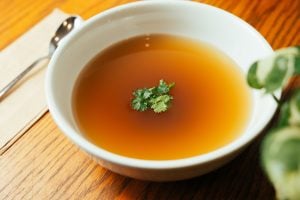 broth in a white bowl garnished with parsley
