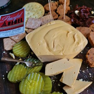 Peaceful Rebel Smoked Gouda vegan cheese with pickle crackers and mock meats
