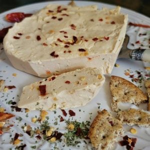 Vegan cheese with chilli flakes and crackers