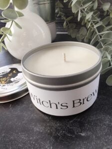 White witch's brew candle with plants