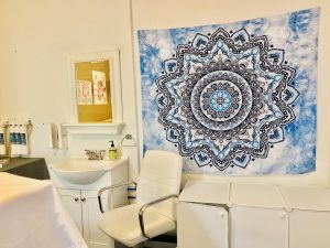 blue mandala tapestry hanging on the wall of medical room