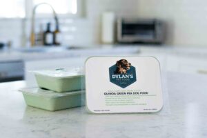Containers of Dylan's Green Pea Dog Food with logo showing on kitchen counter