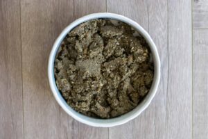 Dylan's Quinoa Black Bean Dog Food in a bowl on wooden background