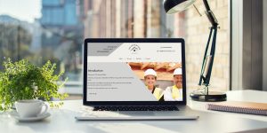 Laptop on desk with builder's website open