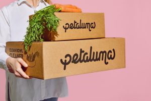 Woman carrying cardboard petaluma boxes
