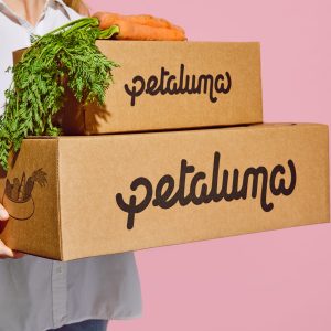 Woman carrying cardboard petaluma boxes
